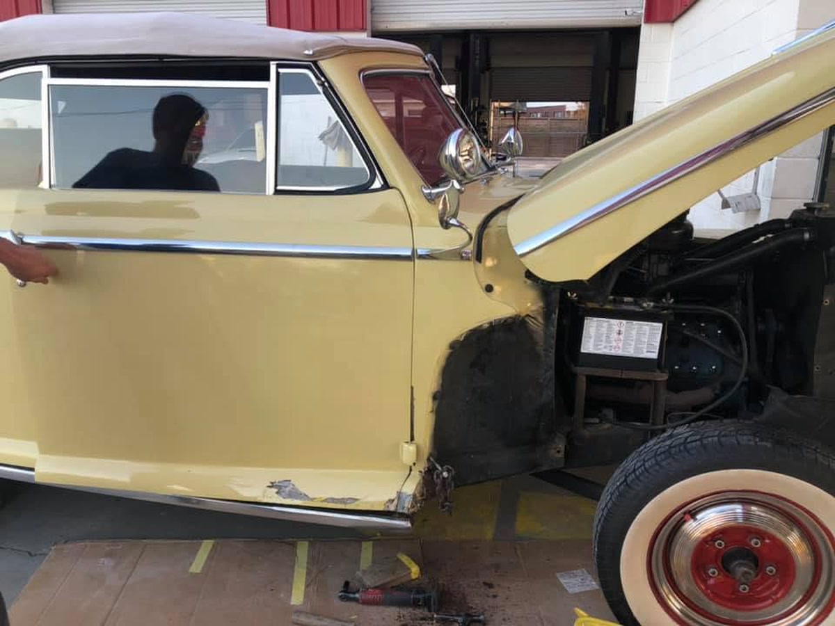 A classic car with its front fender removed during body repair at Superior Collision in Brownsville, TX