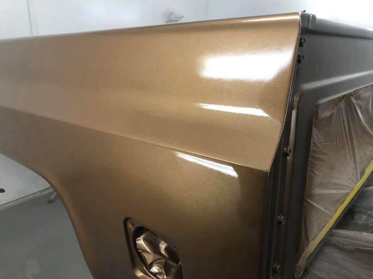 Close-up of a gold metallic finish on a refinished panel at Superior Collision, serving La Feria, TX