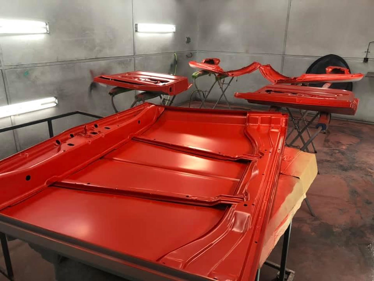 Freshly refinished body panels racked in the paint booth at Superior Collision, serving Port Isabel, TX