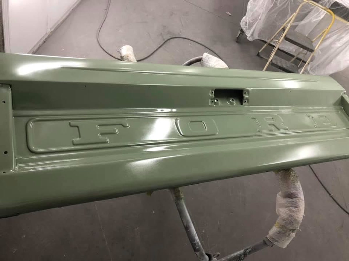 A refinished truck tailgate on a paint stand at Superior Collision, serving Mercedes, TX